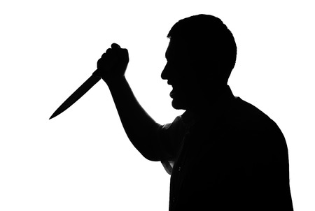 Killer man holding knife in hand. Silhouette pictureの写真素材