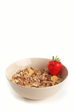 Cereal muesli in brown bowl with strawberryの写真素材