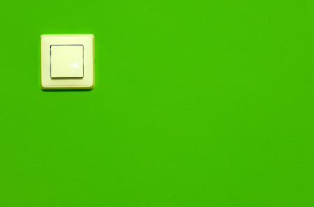Electric switch on green wallの写真素材