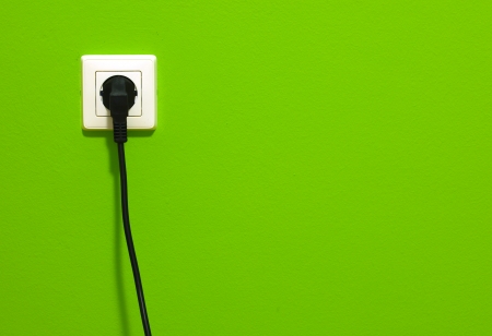 White power point with electric cable on green wallの写真素材