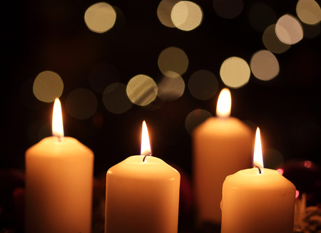 Four candles against abstract backgroundの写真素材