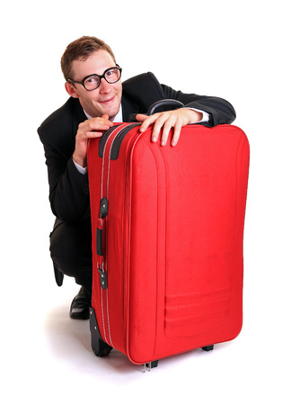 Funny business man hide behind red luggageの写真素材