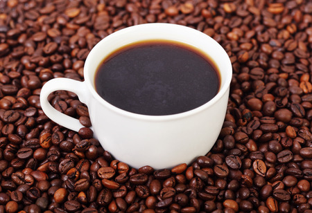 Cup of coffee on beansの写真素材