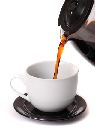 Coffee pouring into cup isolated on whiteの写真素材