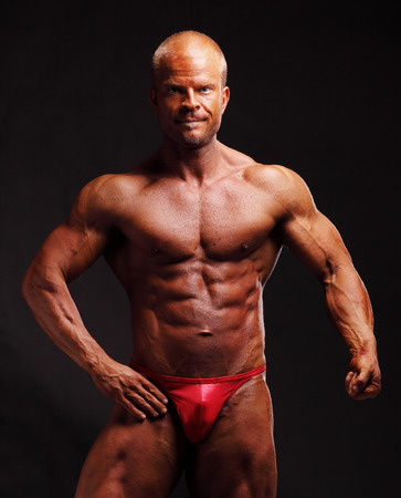 Muscular male bodybuilder posing in studioの写真素材