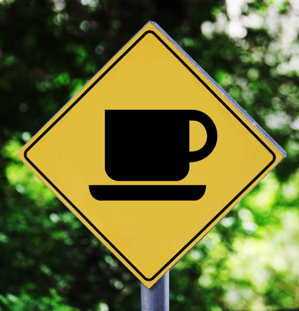 Yellow road sign outdoor with coffee shop pictogramの写真素材