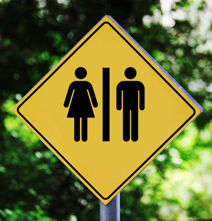 Yellow road sign outdoor with man and woman pictogramの写真素材