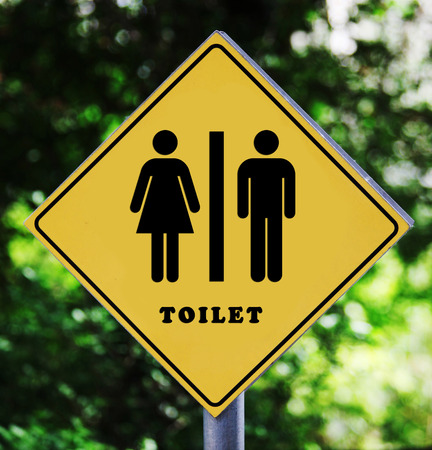 Yellow road sign outdoor with man and woman toilet pictogramの写真素材