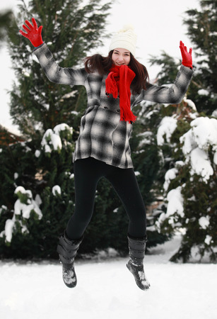 Young beautiful woman outdoor in winter jumpingの写真素材
