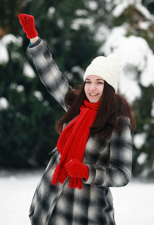 Young woman prepare throwing snowballの写真素材
