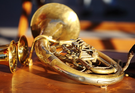 Blowing brass wind instrument on tableの写真素材