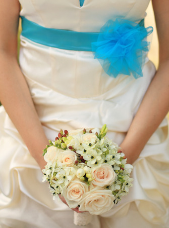 Bride in elegant cloth hold bouquet of flowerの写真素材