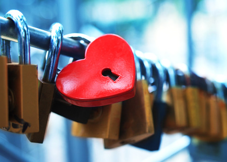 The closed red padlock with heartの写真素材