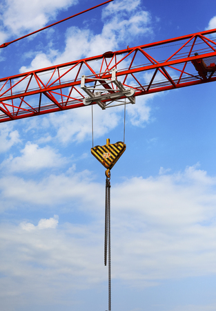 Detail of huge red crane with cloudy skyの写真素材