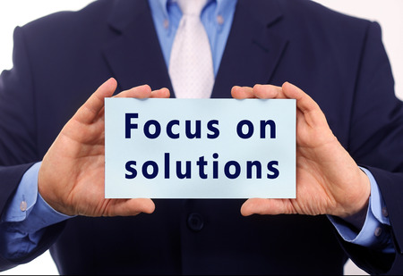 Business man hold paper focus on solution text on it