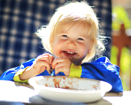 Young sweet child with dirty mouthの写真素材