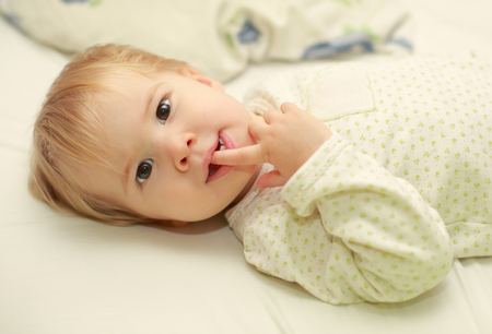 Cute adorable young child in bedの写真素材
