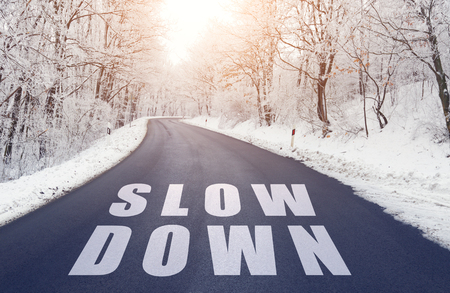 Empty in forest road in winter with slow down textの写真素材
