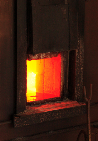 Open iron stove in boiler roomの写真素材