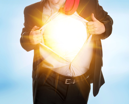 Young angry businessman tearing his shirtの写真素材