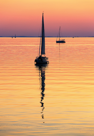 Sailing boats on Lake Balaton at sunsetの写真素材
