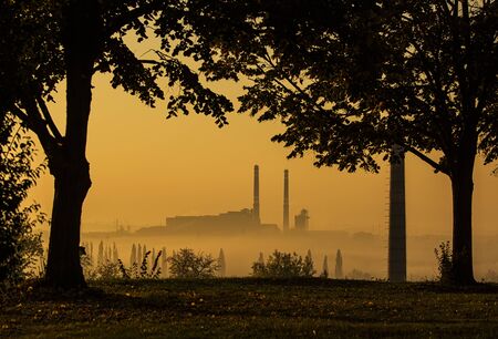 Silhouette of power station in foggy morningの写真素材