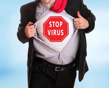 Young angry businessman tearing his shirt corona virus alert on itの写真素材