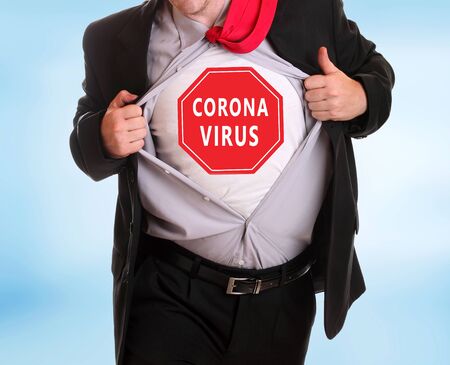 Young angry businessman tearing his shirt corona virus alert on itの写真素材