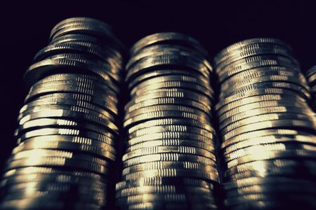 Four coin piles with reflectionの写真素材