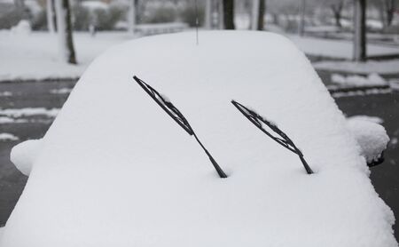 Car covered with snow on street in winterの写真素材
