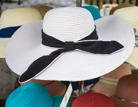 Elegant woman in straw beach hats in shopの写真素材