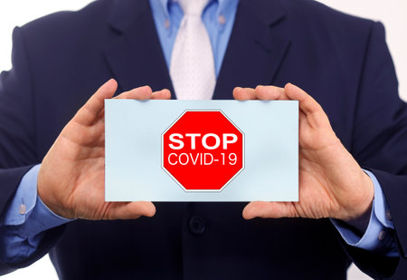 Business man hold paper stop coronavirus text on itの写真素材