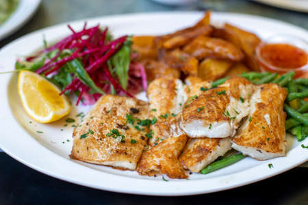 Roasted fish with vegetables on a plate
