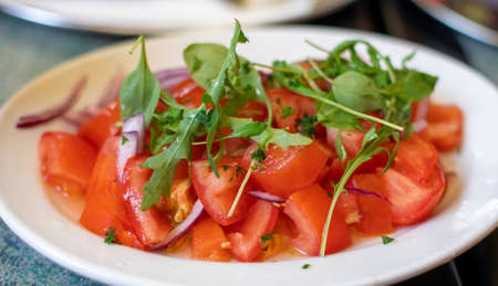 Healthy tomato salad with parsleyの写真素材