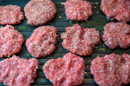Frying four round beef meat for hamburgerの写真素材