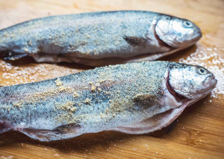 Many headless raw hake fish on a plateの写真素材