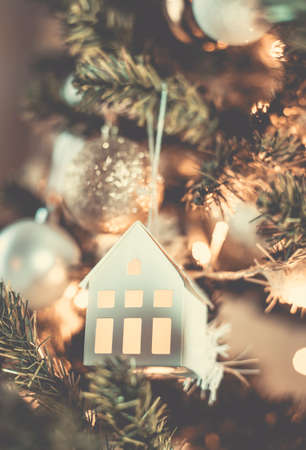 Christmas tree with hanging miniature house decorationの写真素材