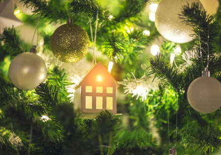 Christmas tree with hanging miniature house decorationの写真素材