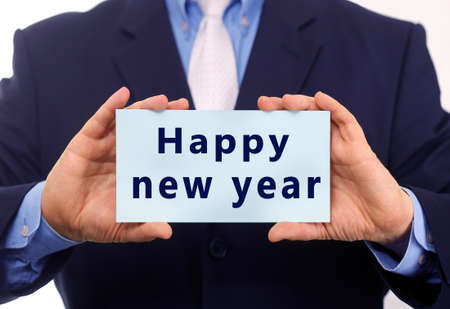 Businessman holding card with text HAPPY NEW YEAR, closeupの写真素材