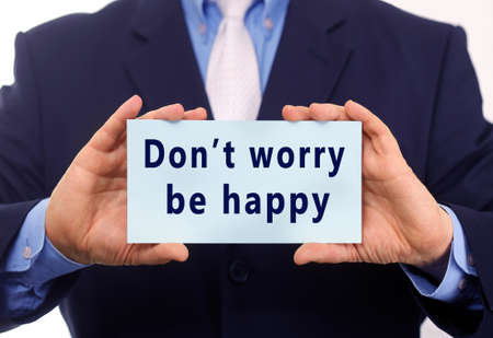 Businessman holding a card with text Don't worry be happy.の写真素材
