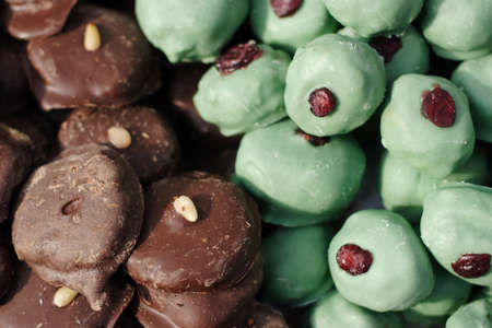 Close up of delicious chocolate candies with nuts and raisinsの写真素材