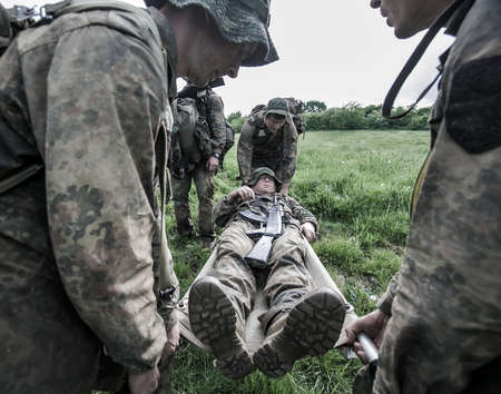 Group of soldiers in military uniform in a field. Selective focus.の写真素材