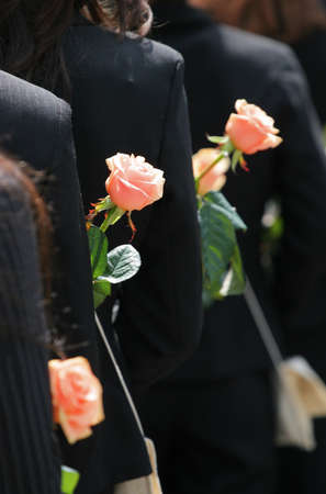 Rear view of a group of women in black clothes with flowersの写真素材
