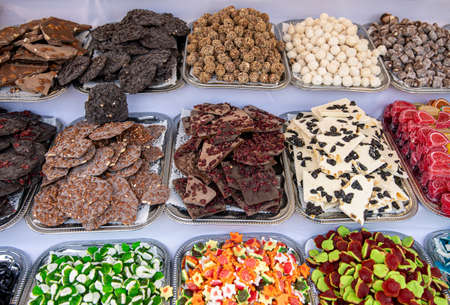 Heap of various candy cake desserts in the marketの写真素材