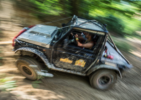 Racing off-road vehicle in the forest. Motion blur.の写真素材