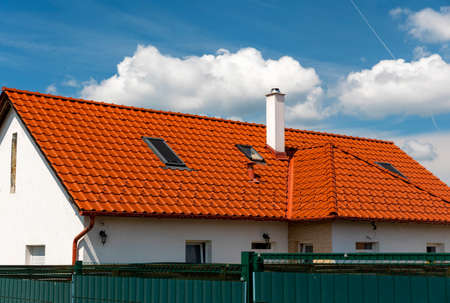 Detail of house roof at blue skyの写真素材