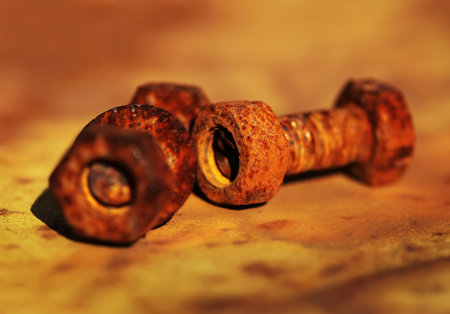 Macro photo of rusted screw on rusty metal plateの写真素材