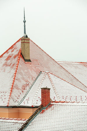 Detail of snow covered roof tiles in cityの写真素材