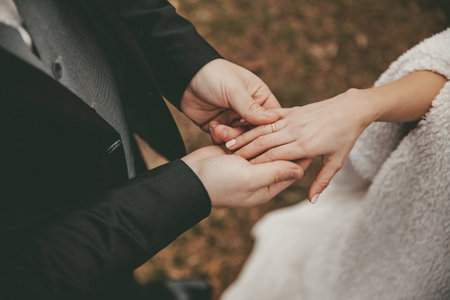Hands of wedding couple with ringの写真素材
