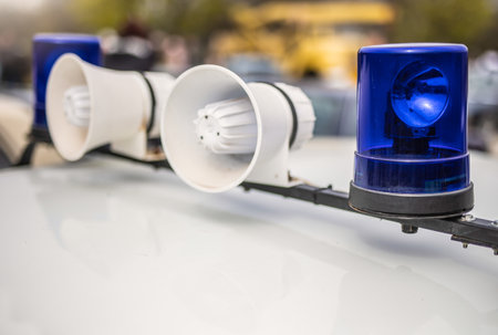 Two loudspeakers and blue lights on top of police carの写真素材
